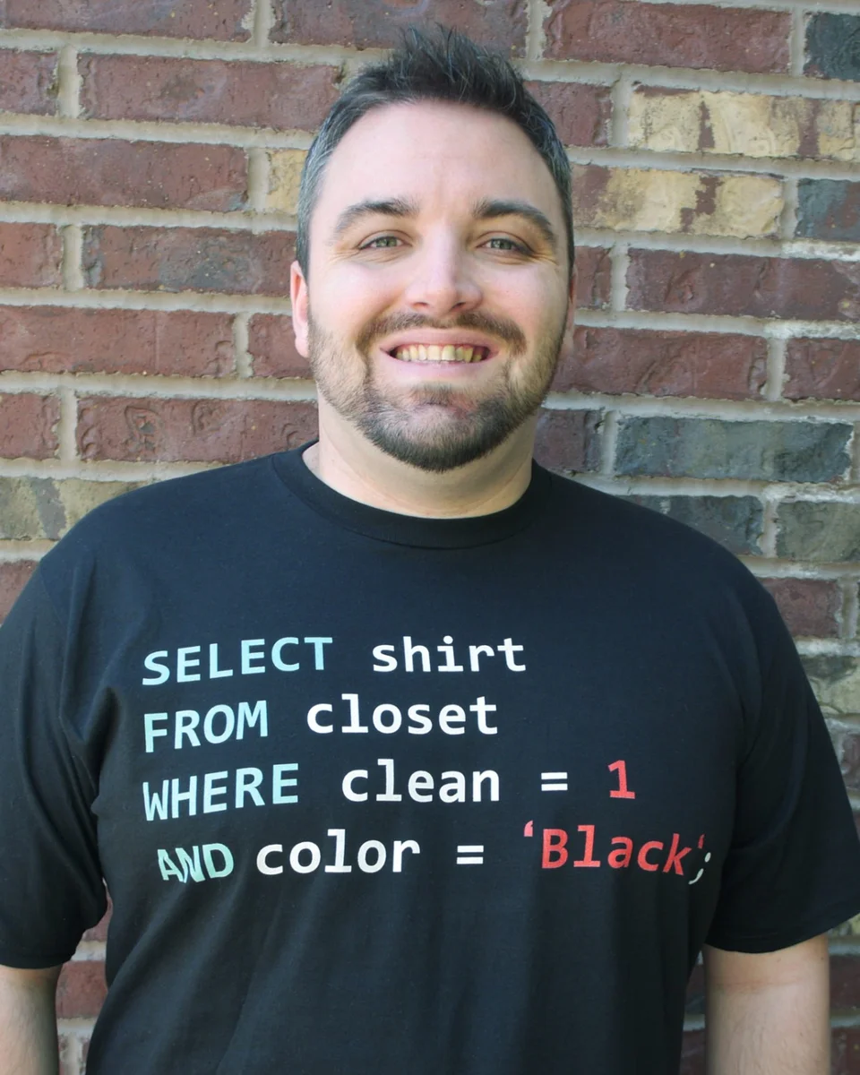 Rob Long, founder of AtLongLast Analytics, wearing a SQL query t-shirt